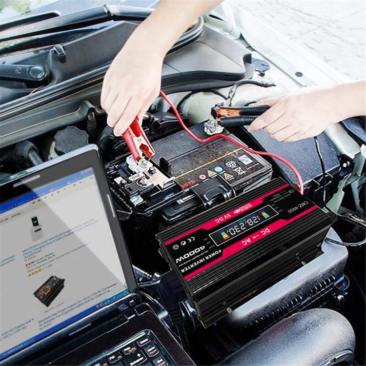 Black 12V car power inverter connected with red and black battery clip cables