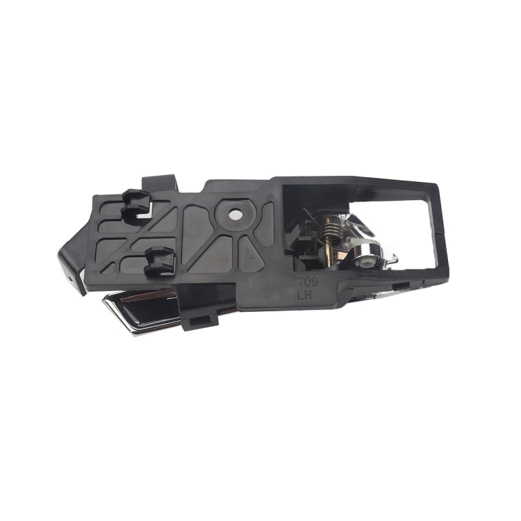 Left inside door handle underside view with black housing and metal latch pieces