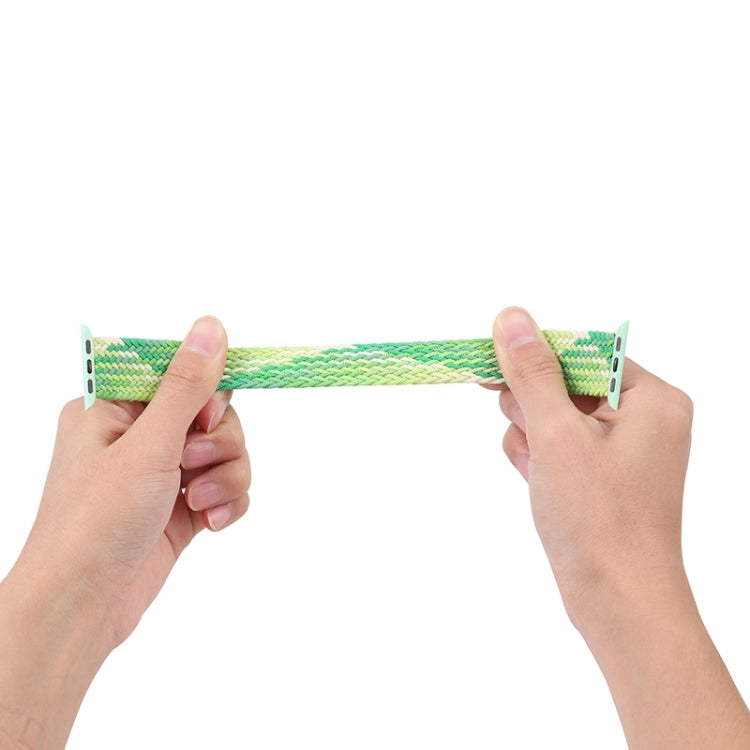Woven nylon Apple Watch band held by hands, lime and mint with metal pin clasp