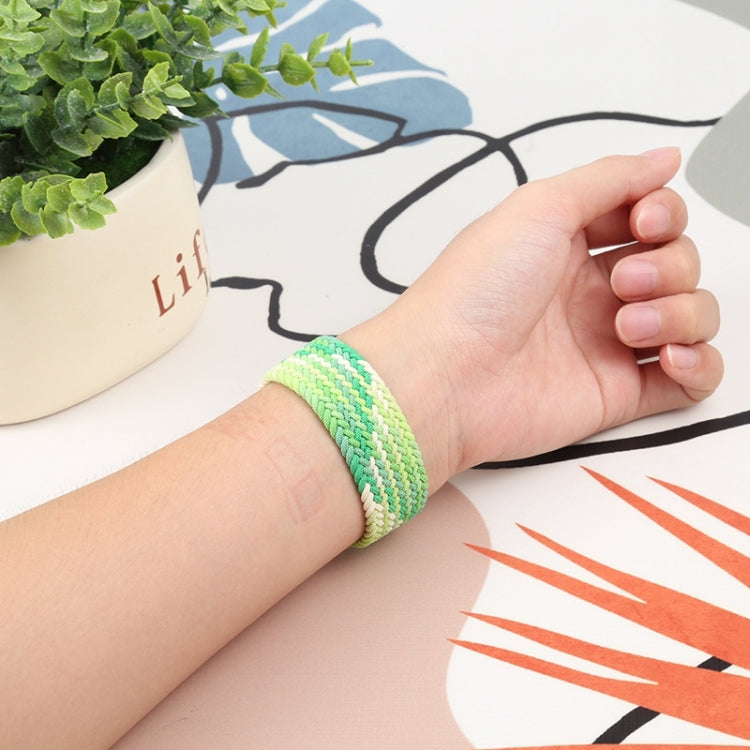 Woven nylon watch band with single loop, light green, on wrist with clasp