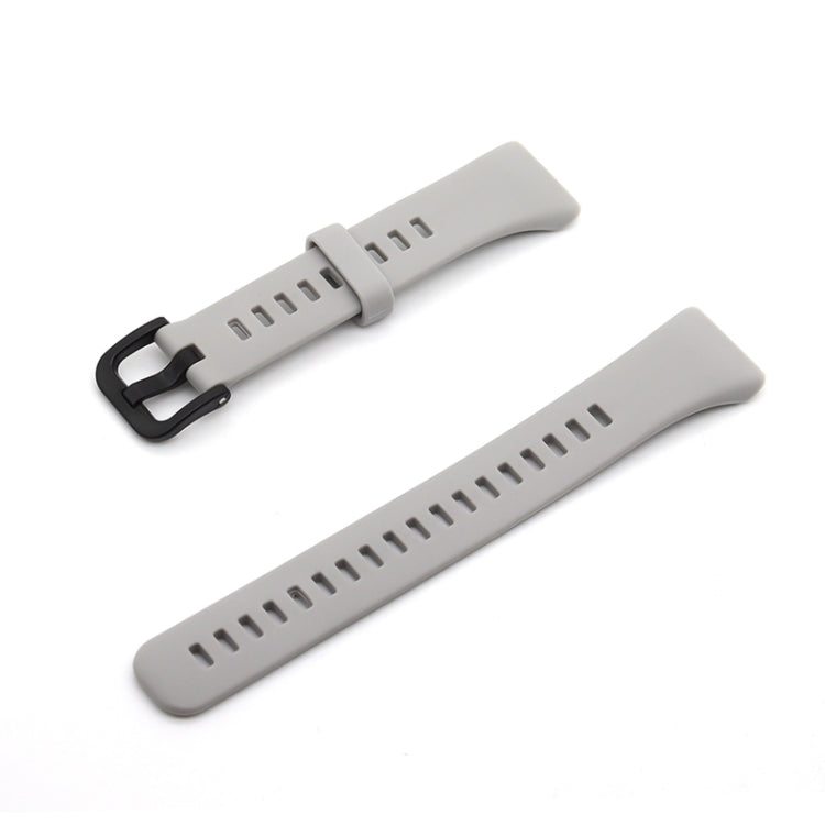 Light gray silicone watch strap with black buckle and perforated sizing holes