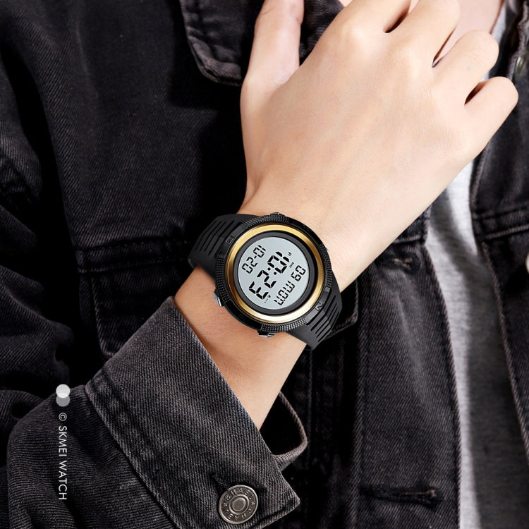 Black electronic digital watch with round bezel, dual time display, luminous face, rubber strap