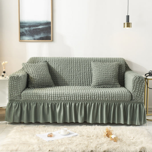 Sage green waffle-knit stretch sofa cover with full-coverage skirt and throw pillows