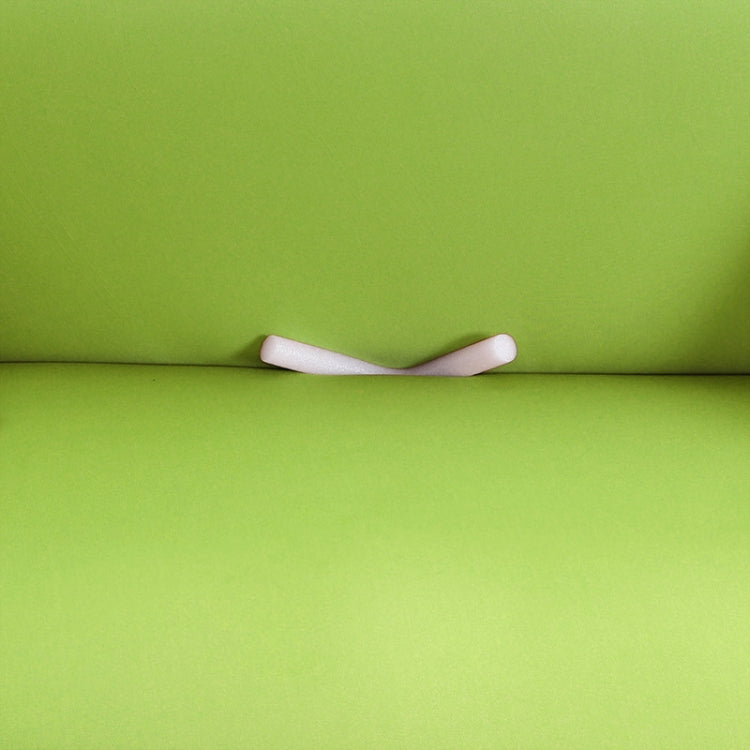 Lime green sofa cover with visible white anti-slip strap detail underneath