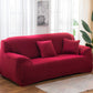 Red elastic full sofa cover with snug wrap over cushions and arms