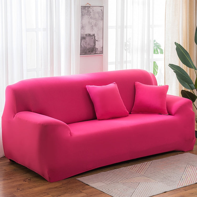 Solid-color full-coverage sofa cover in bright pink with three matching cushions