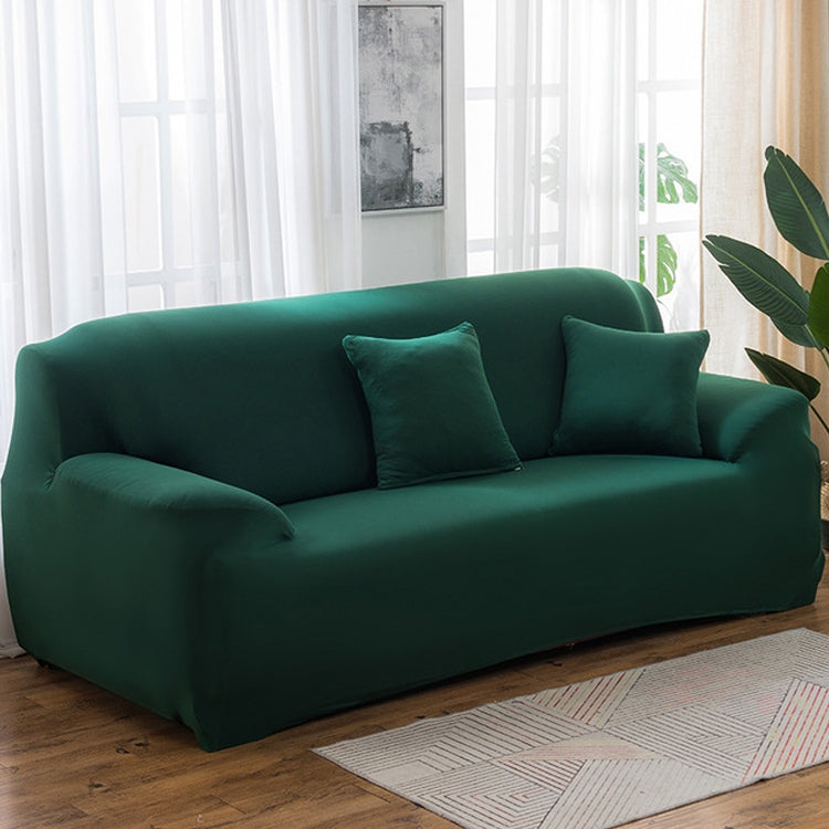 Solid-color full-coverage sofa cover in dark green with three matching cushions