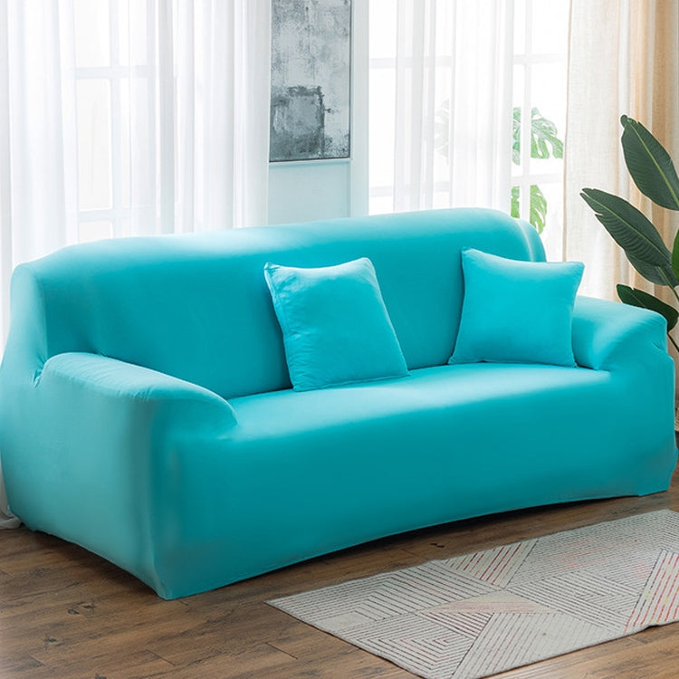 Solid-color full-coverage sofa cover in bright turquoise blue with three matching cushions