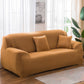 Solid-color full-coverage sofa cover in camel tan with three matching cushions