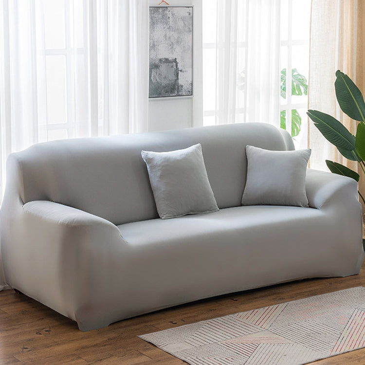 Solid-color full-coverage sofa cover in light gray with matching cushion set