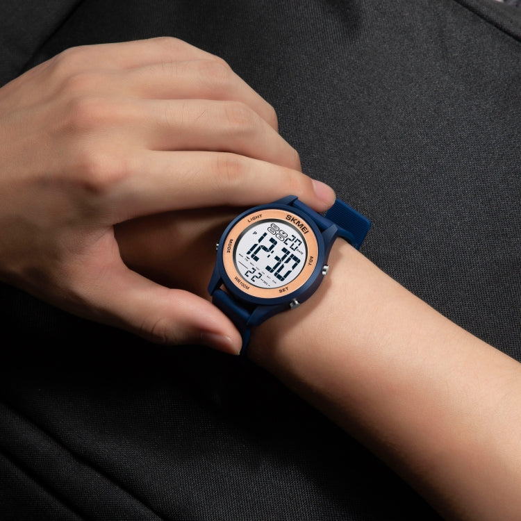 SKMEI digital LED watch on wrist with dark blue silicone strap and lit display