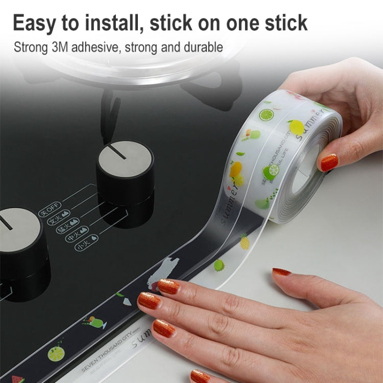 Self-adhesive kitchen border sticker roll being applied along a dark cooktop