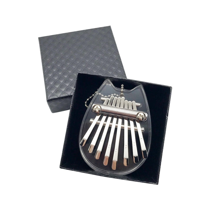 Mini 8-tone kalimba with dark heart-shaped body and metal tines, in black case