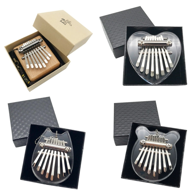 Mini 8-tone kalimba in assorted cases, showing wood and acrylic heart bodies
