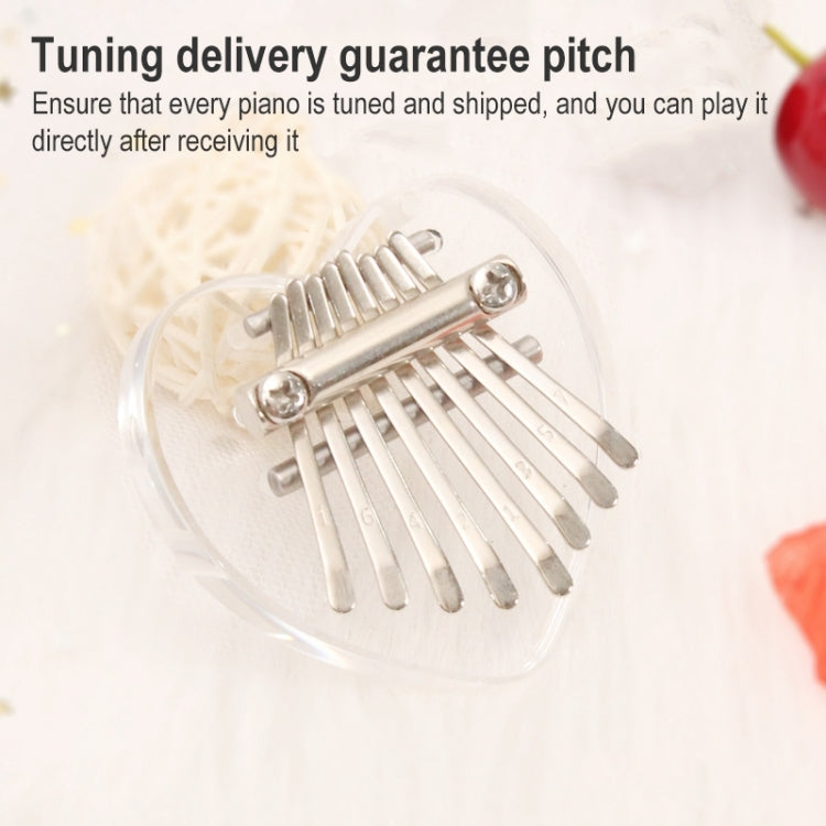 Mini 8-tone transparent acrylic kalimba with metal tines, close-up