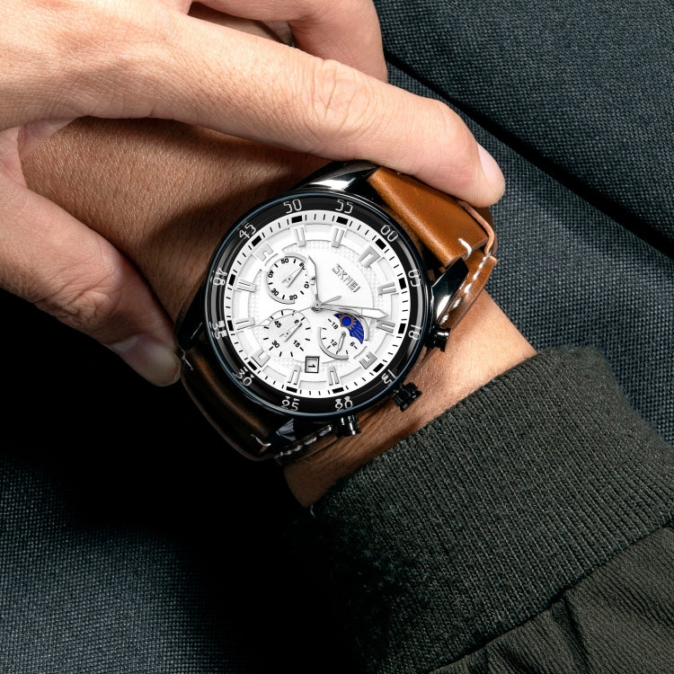 Quartz moonphase watch on wrist with brown leather strap and white multi-dial face