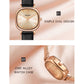 Women’s quartz watch close-up with black leather strap and oval cream dial