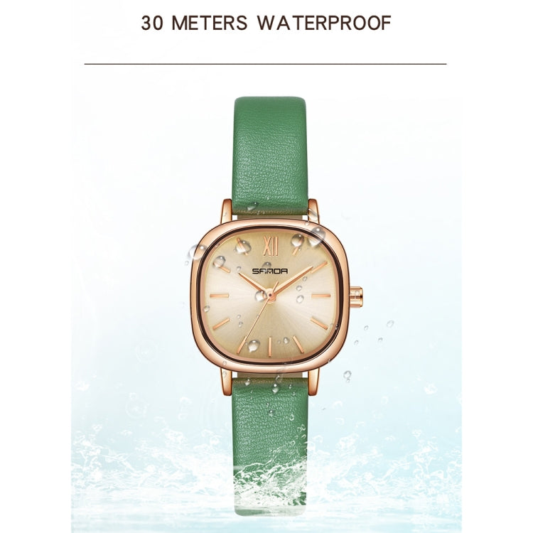 Women’s quartz watch with green leather strap and oval cream dial with gold-tone hands