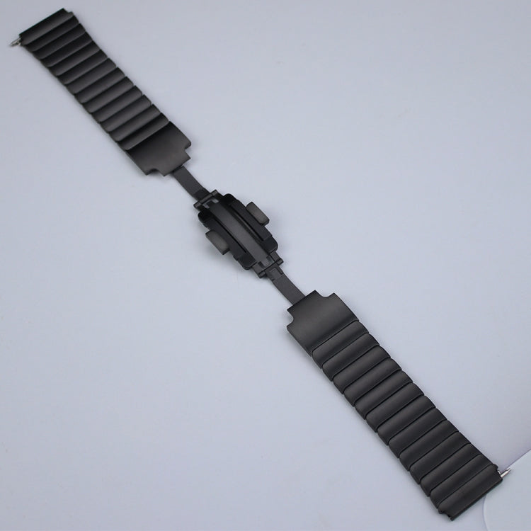 Black ribbed stainless steel watch band laid flat, clasp and connector end visible