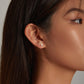 Woman wearing corgi ear stud earrings, sterling silver with orange and white enamel