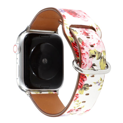 Floral watch strap with white pink and green flower pattern, brown leather underside, metal clasp.