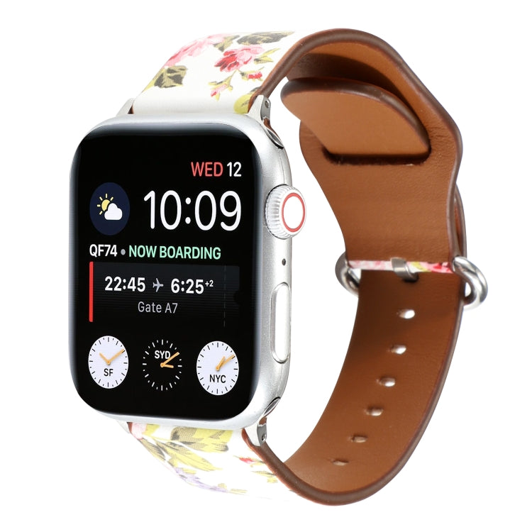 Floral watch strap with white and pink rose floral print, brown leather back, silver pin clasp.