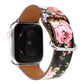 Floral watch strap with dark background and pink floral print, brown leather interior, metal clasp.