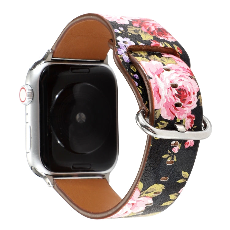 Floral watch strap with dark background and pink floral print, brown leather interior, metal clasp.