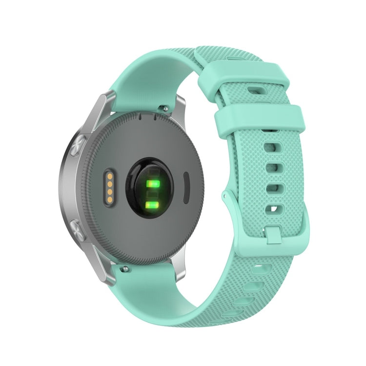 Silicone smartwatch replacement strap in mint green, textured band with metal clasp and holes
