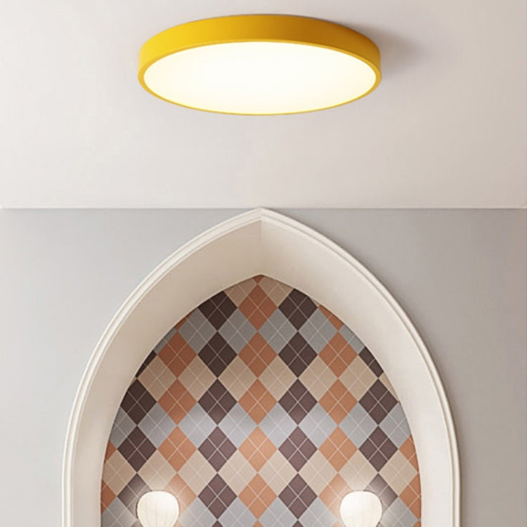 Round flush LED ceiling lamp underside with frosted diffuser and yellow trim