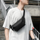 Black crossbody waist bag with zip pocket worn with adjustable strap