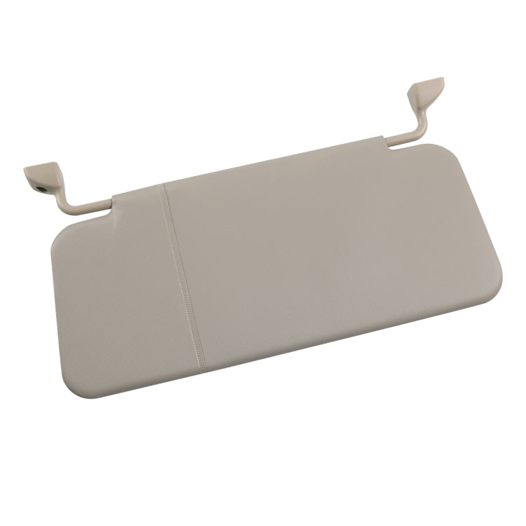 Beige adjustable car sun visor with side clips and center seam, angled view