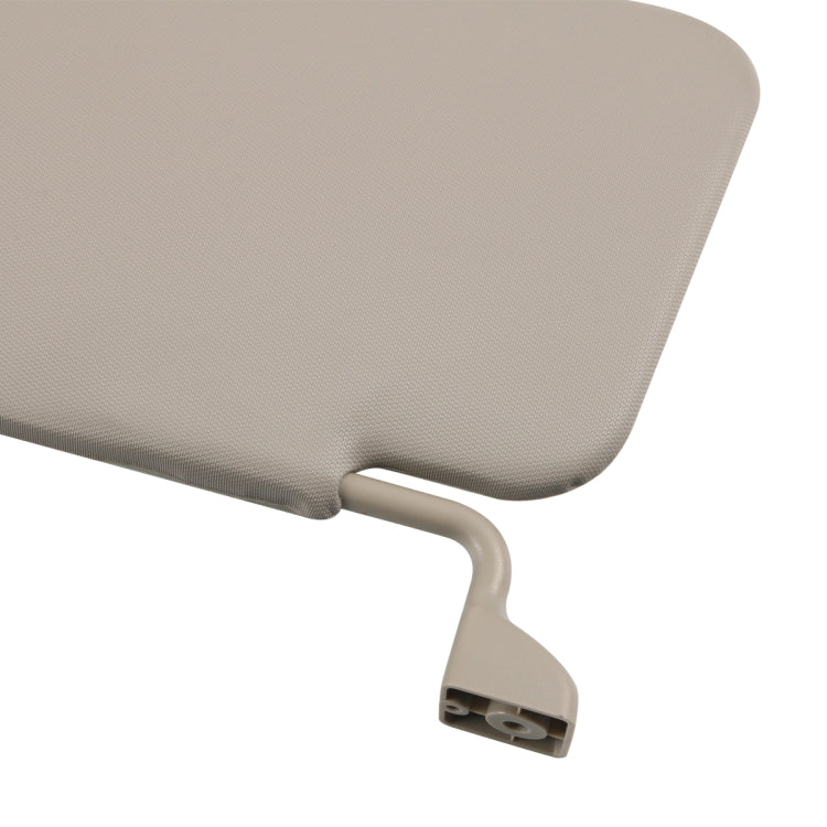 Close-up of light gray sun visor with curved mounting arm and textured surface