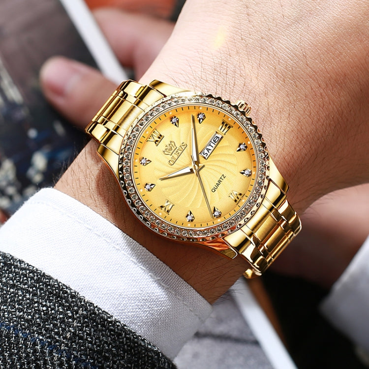 Gold-tone men’s quartz watch on wrist with rhinestone bezel and link bracelet