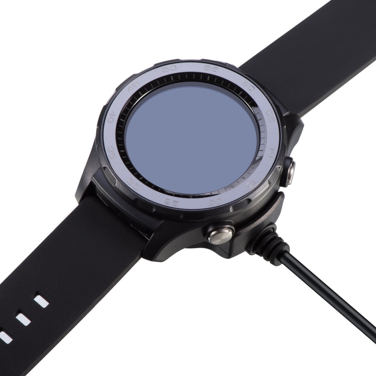 Watch placed on black cradle charger with charging cable connected