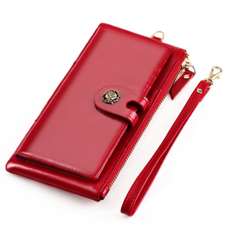 Red zip-around leather wallet with snap clasp; wrist strap; opened view.
