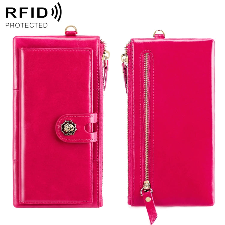 Pink leather wallet with snap strap and gold zipper; front view.