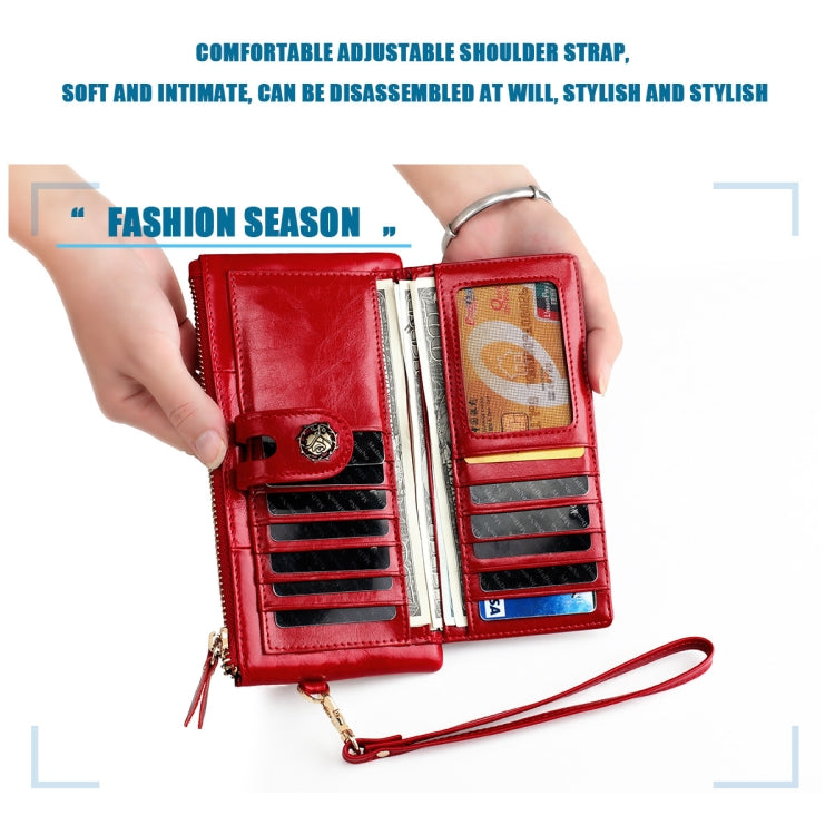 Red wallet open showing multiple card slots and gold zipper pull with wrist strap.