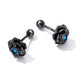 Black rose ear studs with blue center stone, spherical post backs