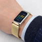 Gold magnetic metal mesh watch band on wrist, rectangular smartwatch with dark display