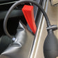 Dent repair hook tool with red handle positioned near interior trim