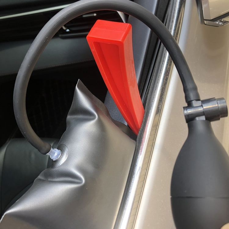 Dent repair hook tool with red handle positioned near interior trim
