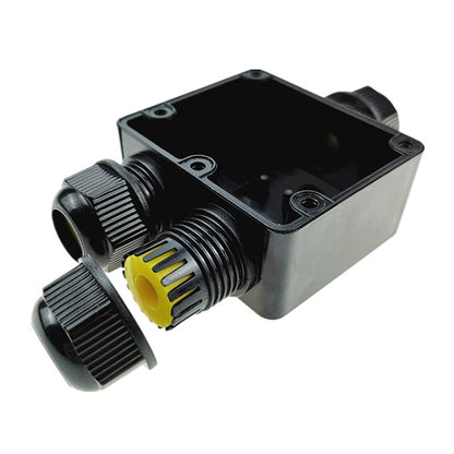 IP68 waterproof junction box with cable glands, dark housing, and yellow seal inserts