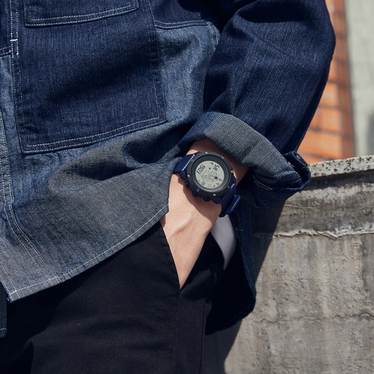 Dark blue luminous astronaut electronic watch on wrist with round case and digital display