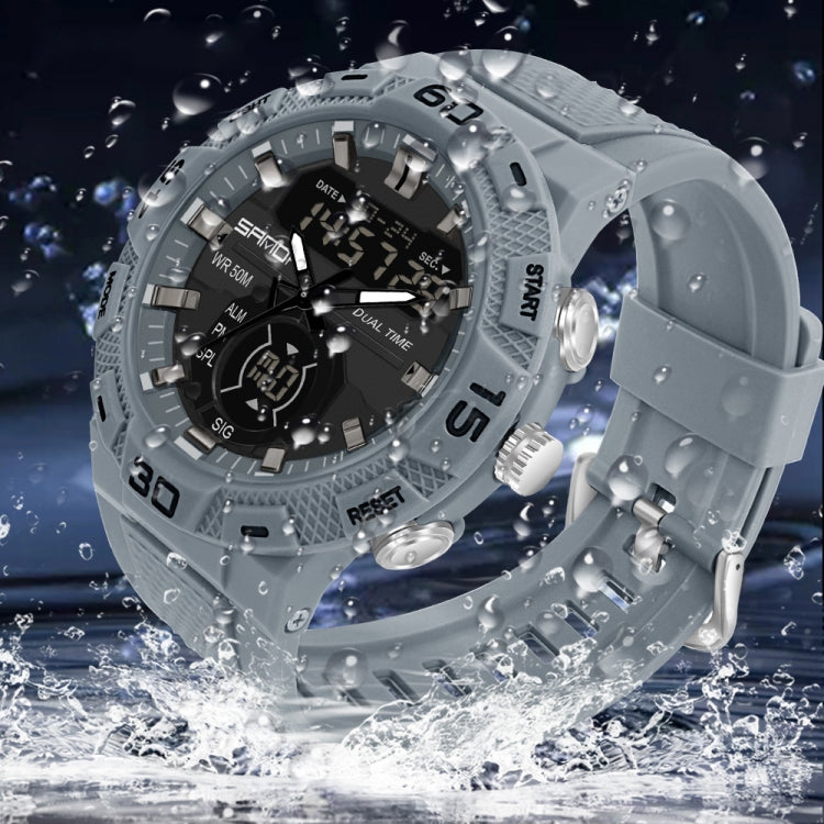 Grey dual display digital watch with water droplets on rugged bezel and silicone strap