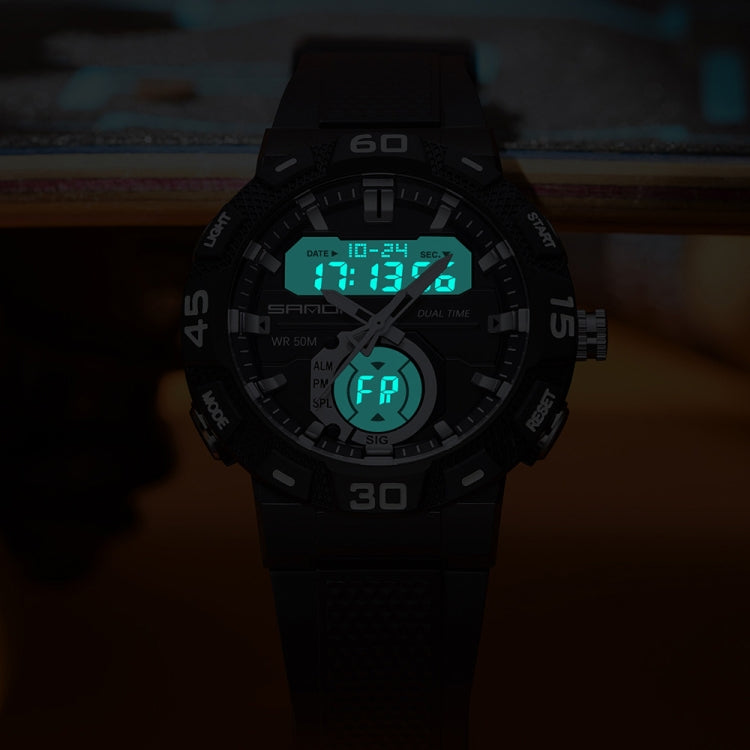 Black dual display digital watch with glowing green screen and rubber strap