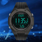 Black digital luminous watch with green backlit display, chunky silicone strap