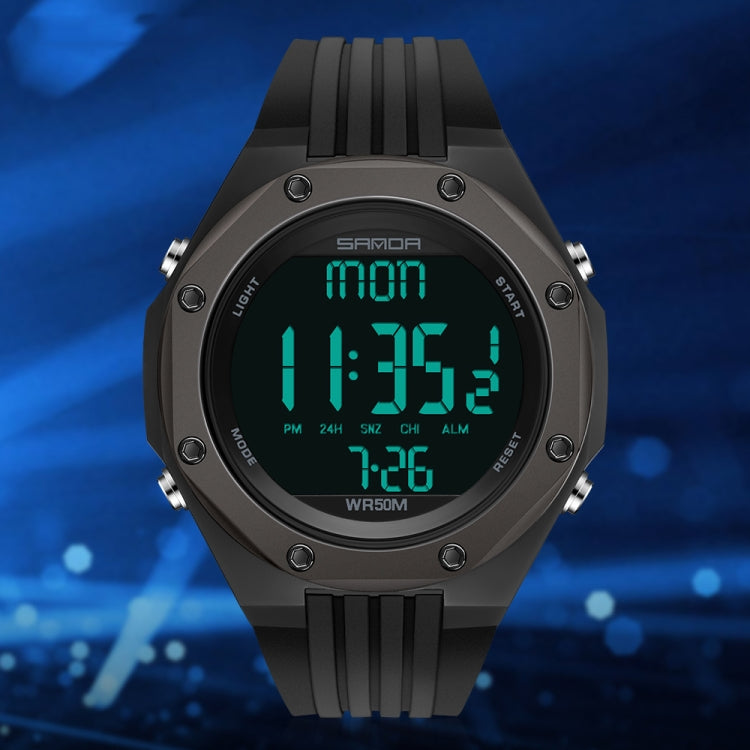 Black digital luminous watch with green backlit display, chunky silicone strap