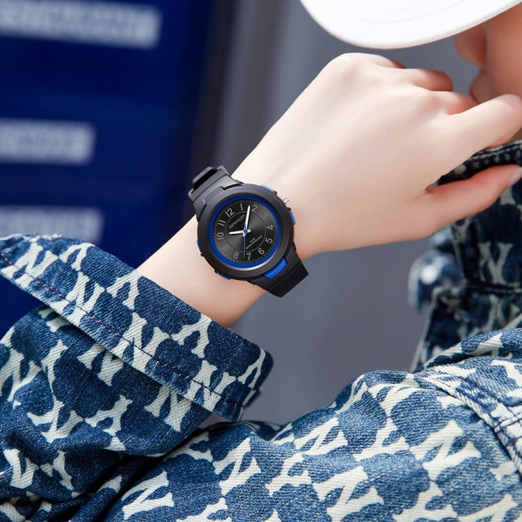 Waterproof sports electronic watch with blue dial and black strap, wrist close-up