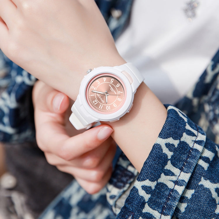 Waterproof sports electronic watch with rose dial and white strap, wrist close-up